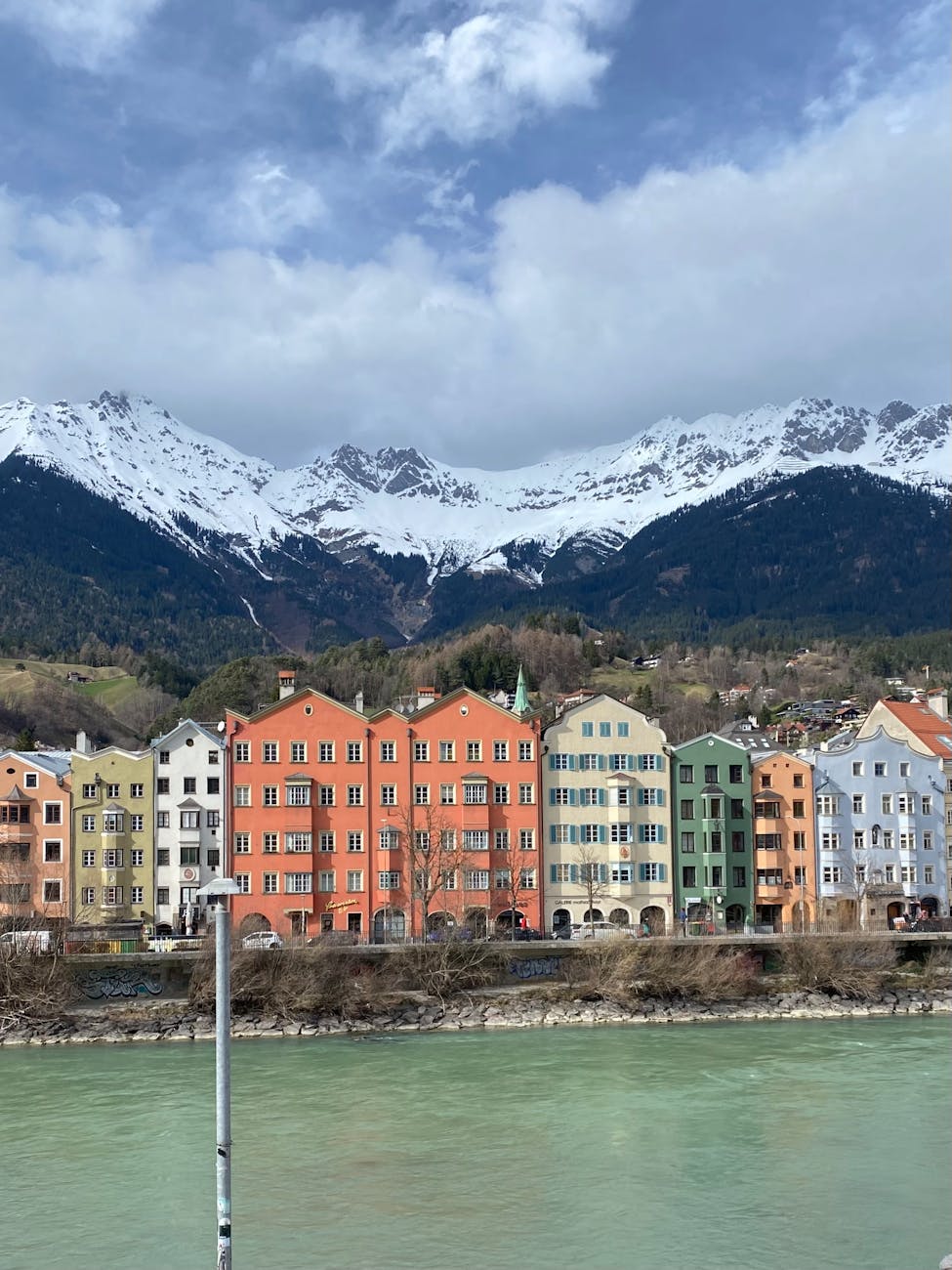 colorful innsbruck houses against snowy alps